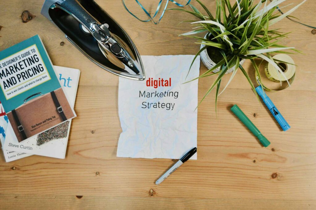 Desk with paper that reads digital marketing strategy
